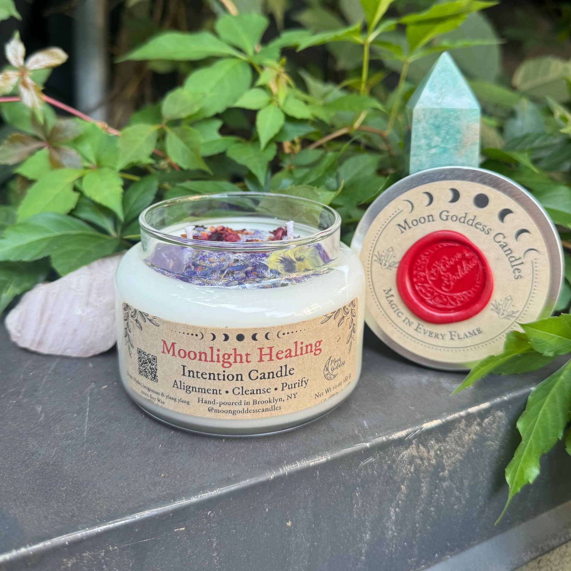 Moonlight Healing Intention Candle on a stone surface with greenery in the background