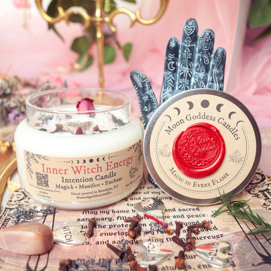 Inner Witch Energy Intention Candle by Moon Goddess Candles, hand-poured in Brooklyn and adorned with herbs, glitter, and rose petals, displayed with witchy charms and ritual decor to support manifestation, enchantment, and personal magick
